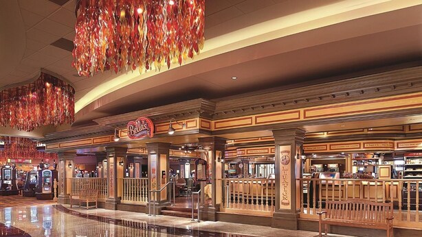 A spacious lobby with a polished marble floor, a 'Bellis' restaurant, and a bar area.