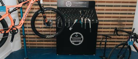 A bicycle repair station with tools and a sign that reads "CYCLING-FRIENDLY.COM".