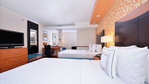 A hotel room with a large bed, a desk with a chair, a television, and a wall-mounted lamp. - Fairfield Inn & Suites by Marriott Asheboro (Asheboro)