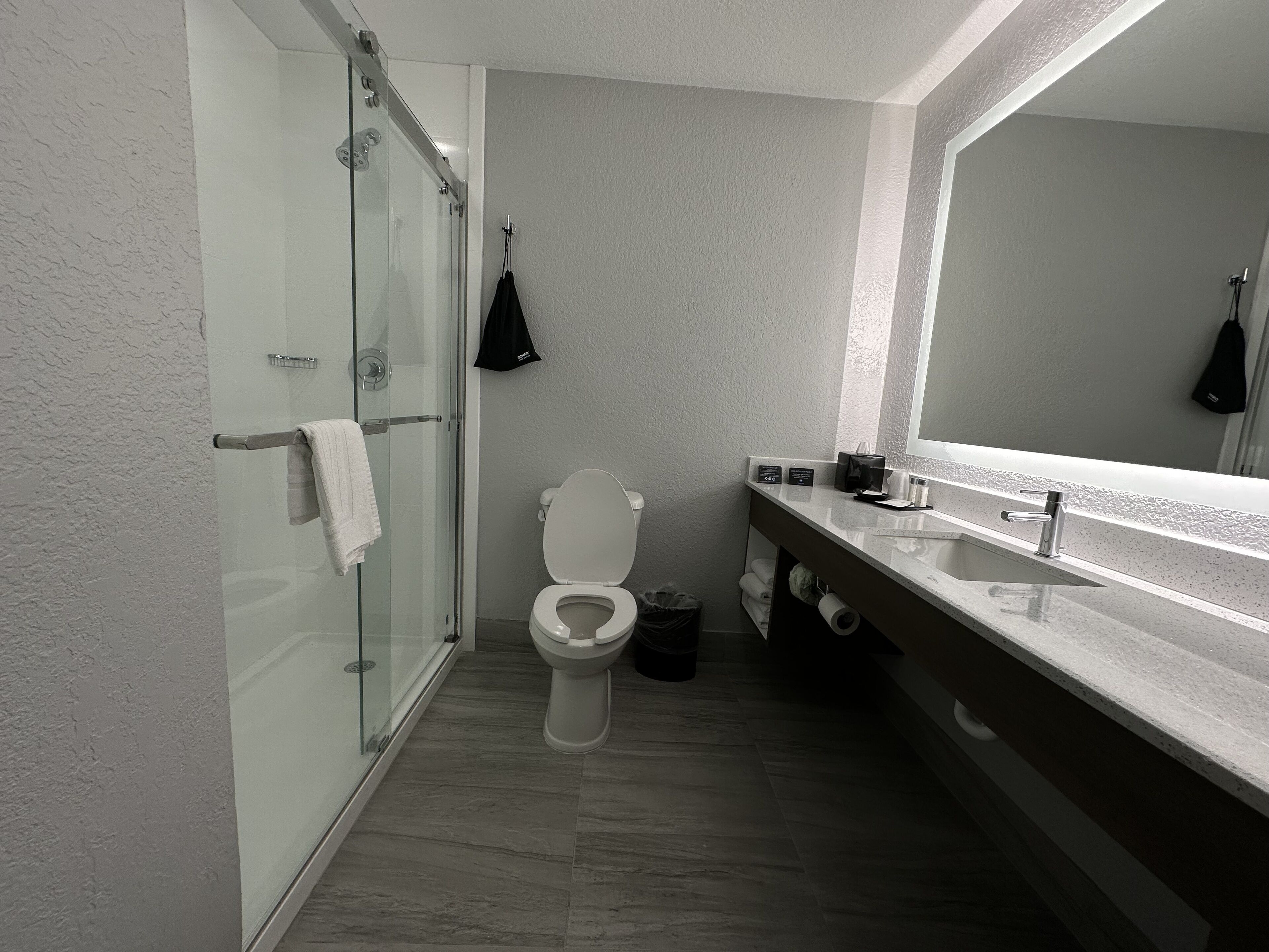 combined shower/bathtub, designer toiletries, hair dryer, towels