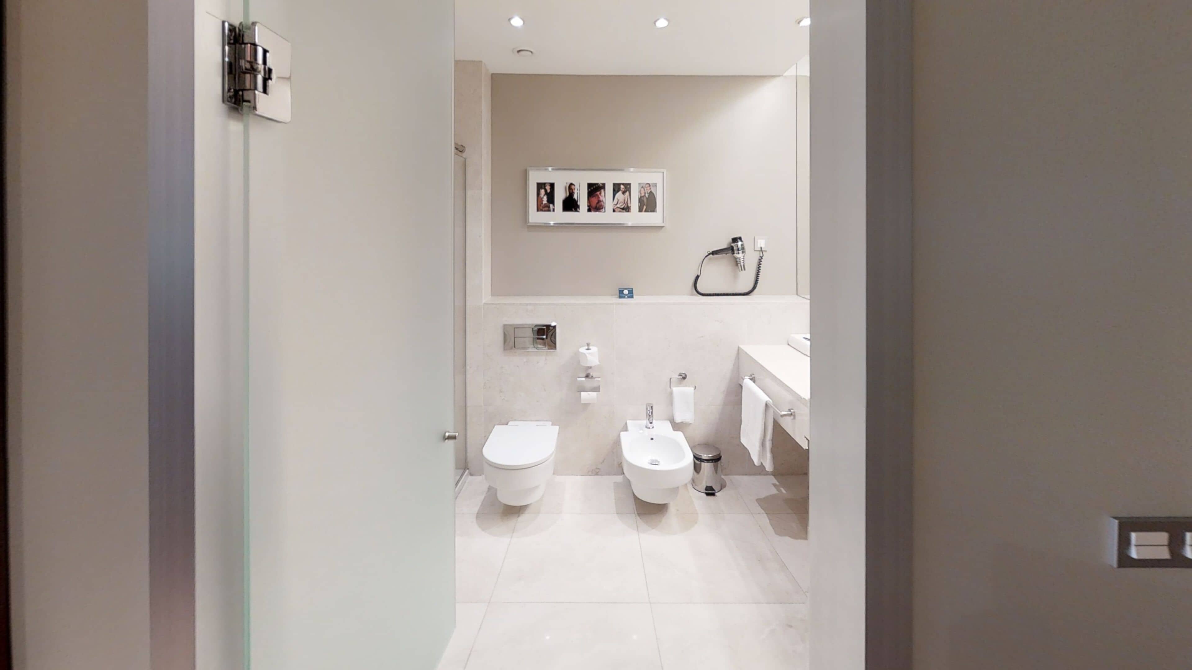 Ein modernes Badezimmer mit Toilette, Bidet und Waschbecken.