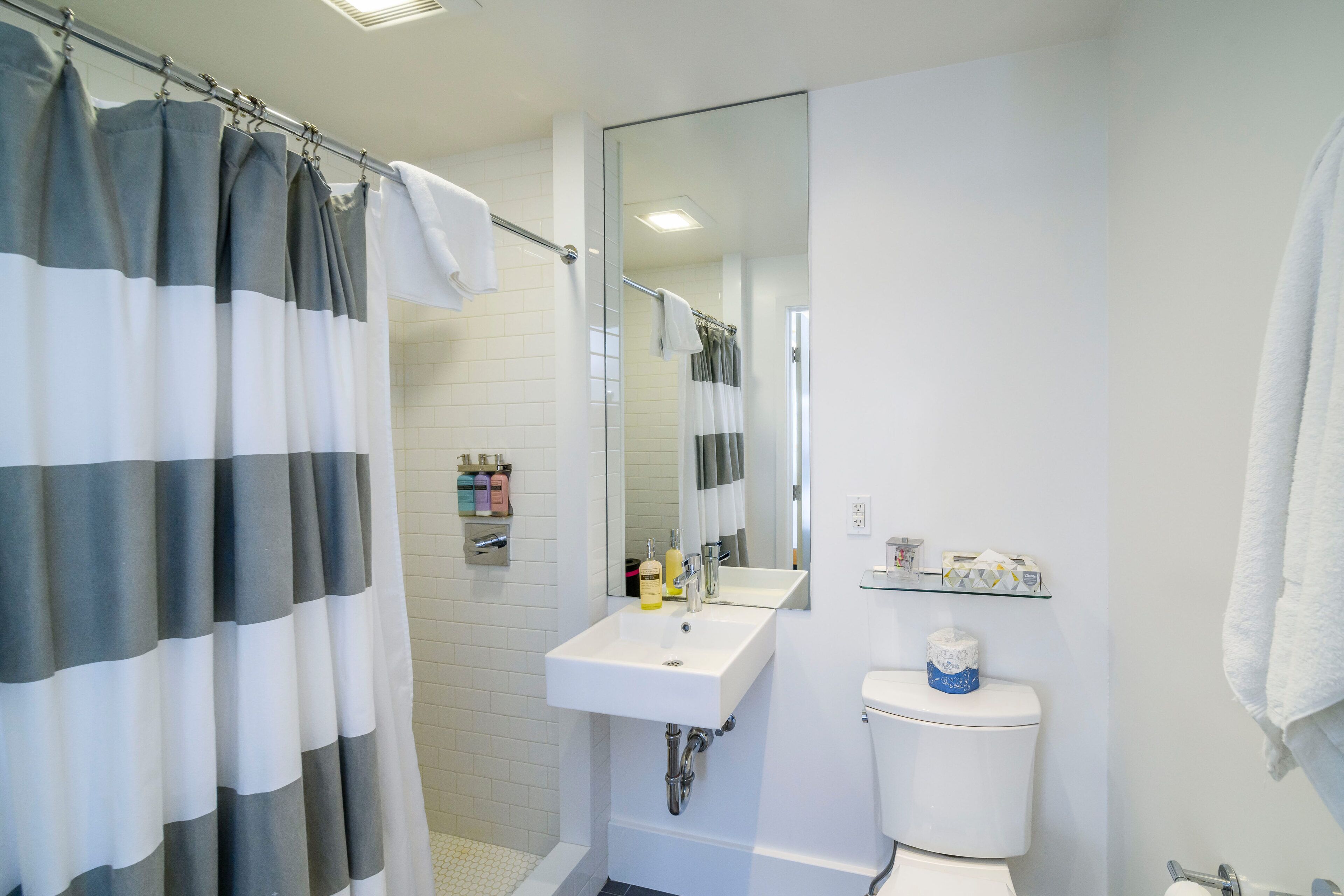 superior room, 1 queen bed | bathroom | rainfall showerhead, free toiletries, hair dryer, towels