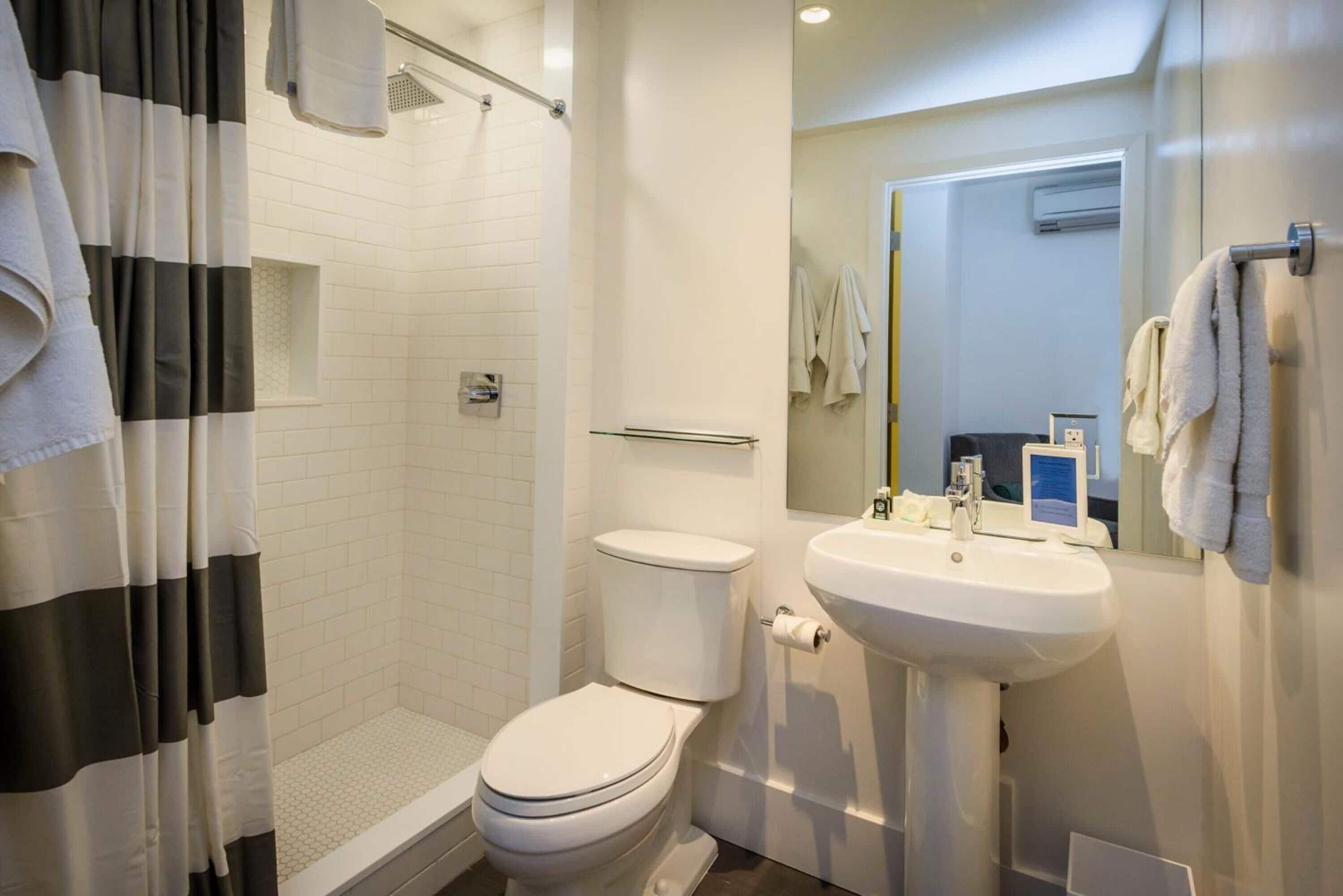 superior room, 1 queen bed | bathroom | rainfall showerhead, free toiletries, hair dryer, towels
