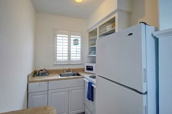Efficiency (1 King Bed) | Private kitchen | Fridge, microwave at Castle by the Sea