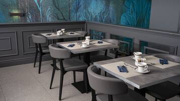 A modern restaurant with a minimalist design, featuring grey and black furniture, and a large abstract painting on the wall.