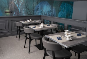 A modern restaurant with a minimalist design, featuring grey and black furniture, and a large abstract painting on the wall.