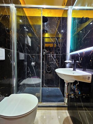 A modern bathroom with a glass-enclosed shower, a white sink, and a bathtub. - Ferrari (Rome)