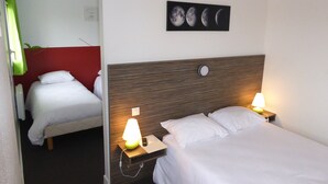 A hotel room with two beds, a red accent wall, a wall-mounted picture of the moon phases, and bedside lamps.
