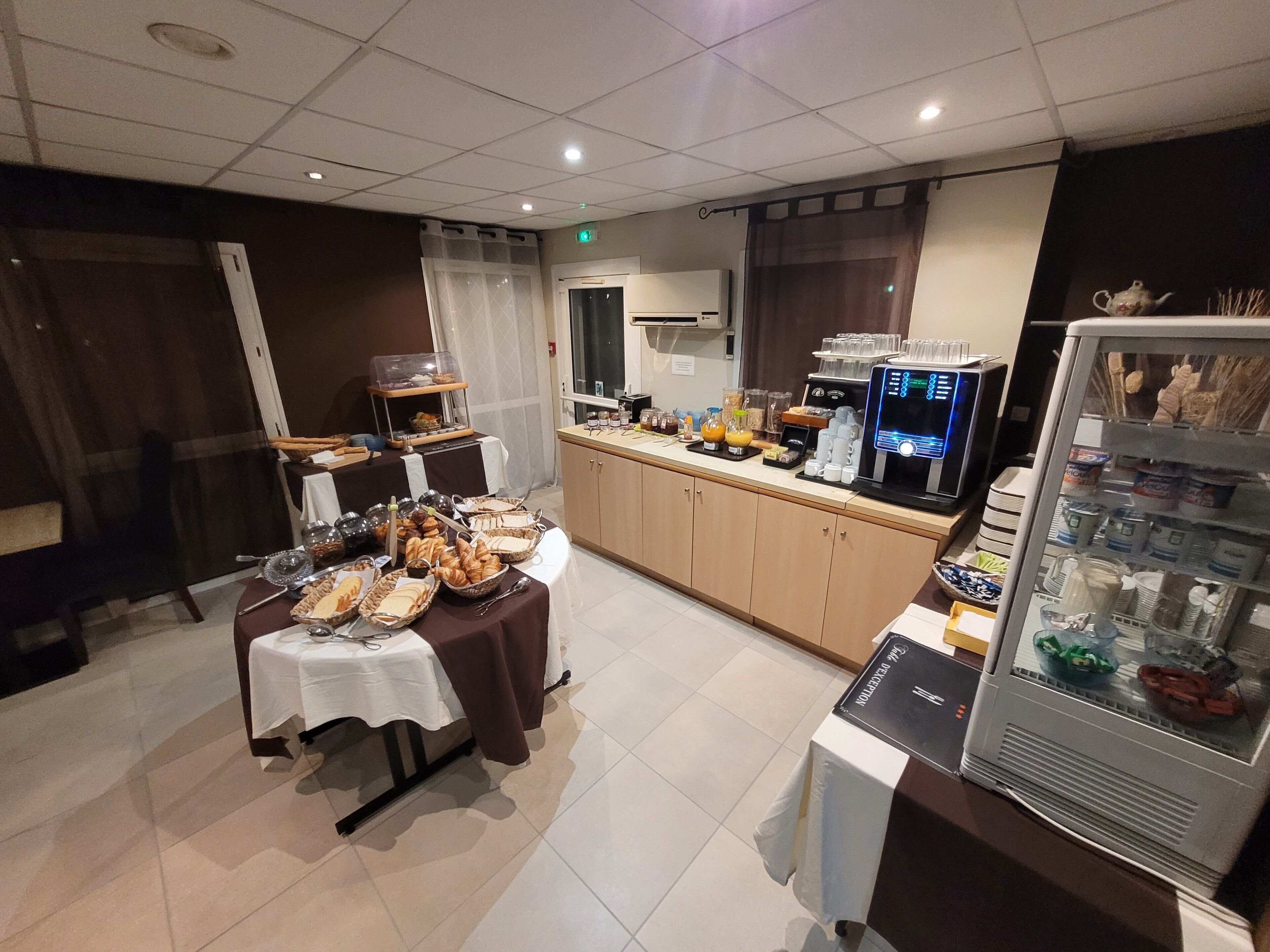 A buffet setup with various food items and a coffee machine.