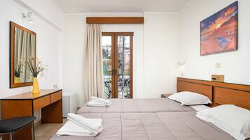 Triple Room | Minibar, in-room safe, desk, cots/infant beds