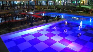 Seasonal outdoor pool, open 9 AM to 8:00 PM, pool umbrellas