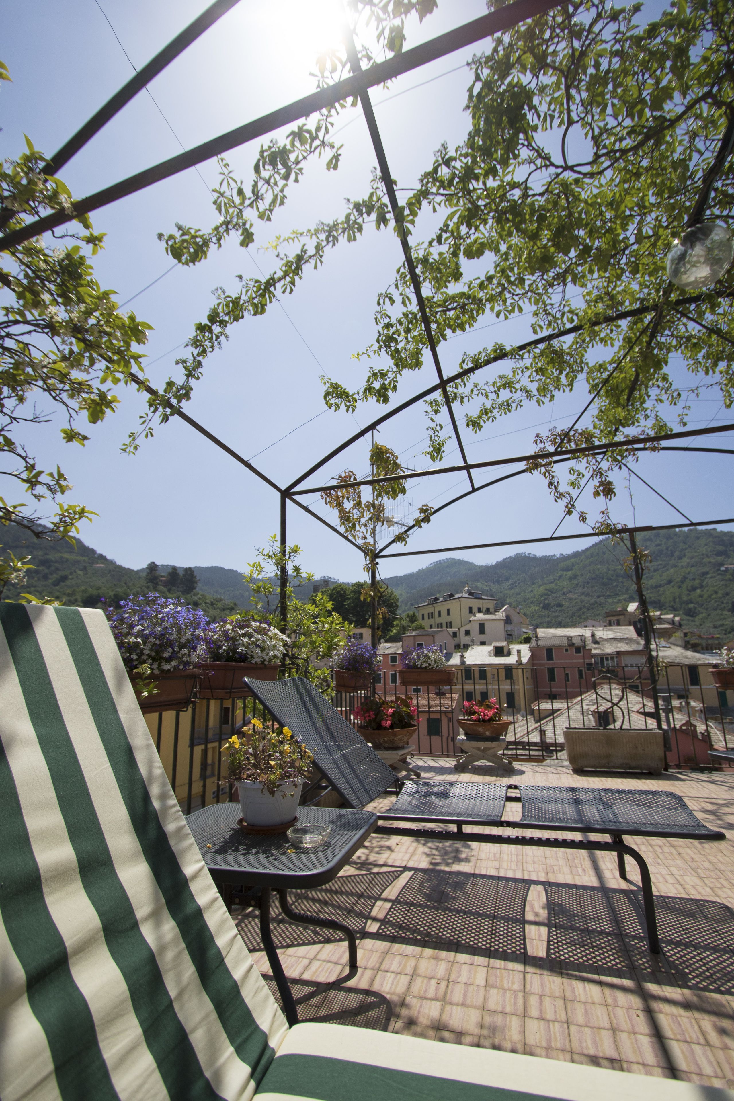 An outdoor seating area with a view of a mountainous landscape.