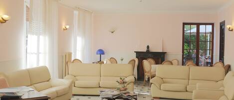 A living room with two beige sofas, a coffee table, and a patterned rug.