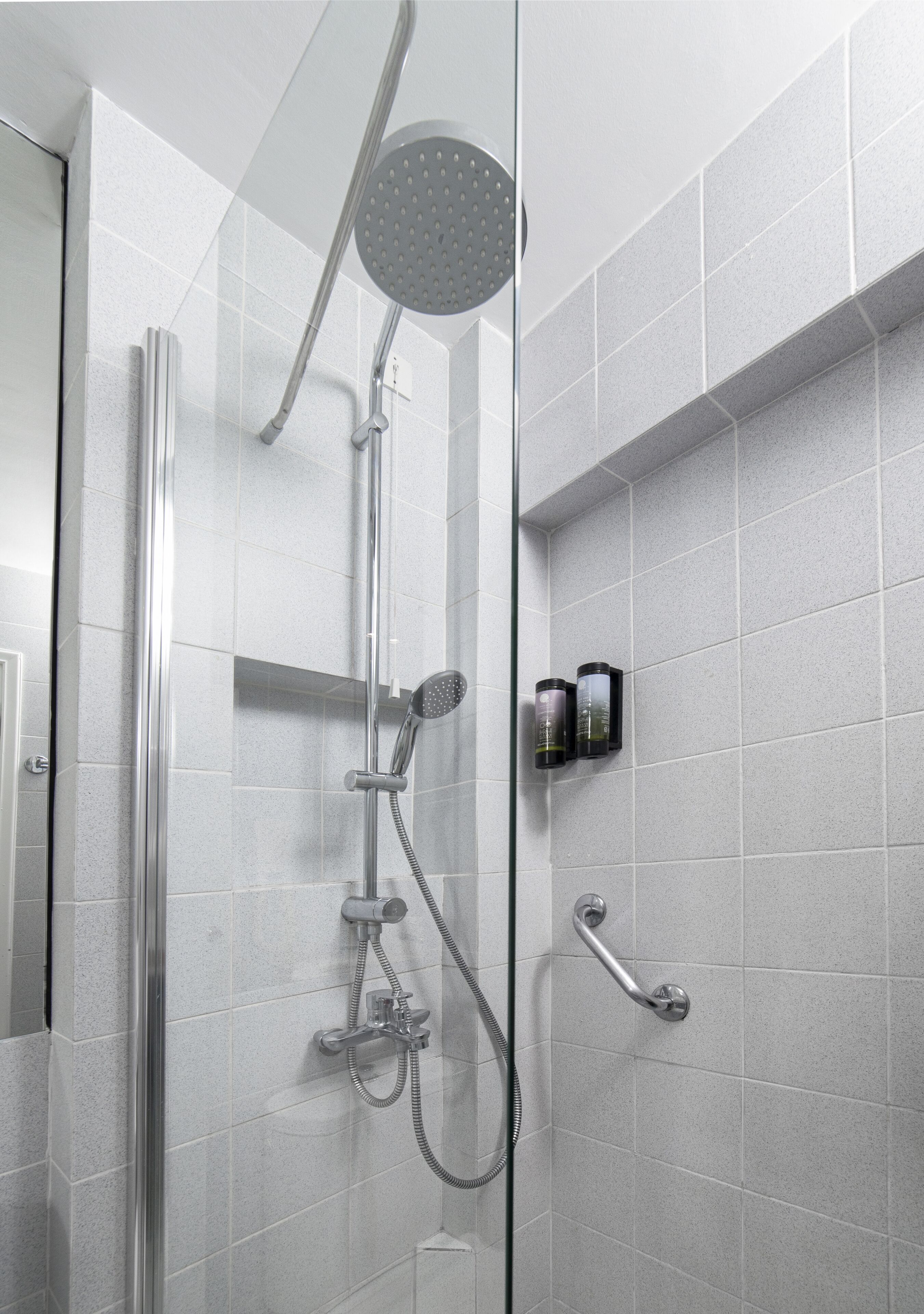 shower, hair dryer, slippers, towels