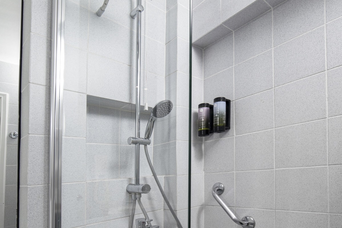 shower, hair dryer, slippers, towels