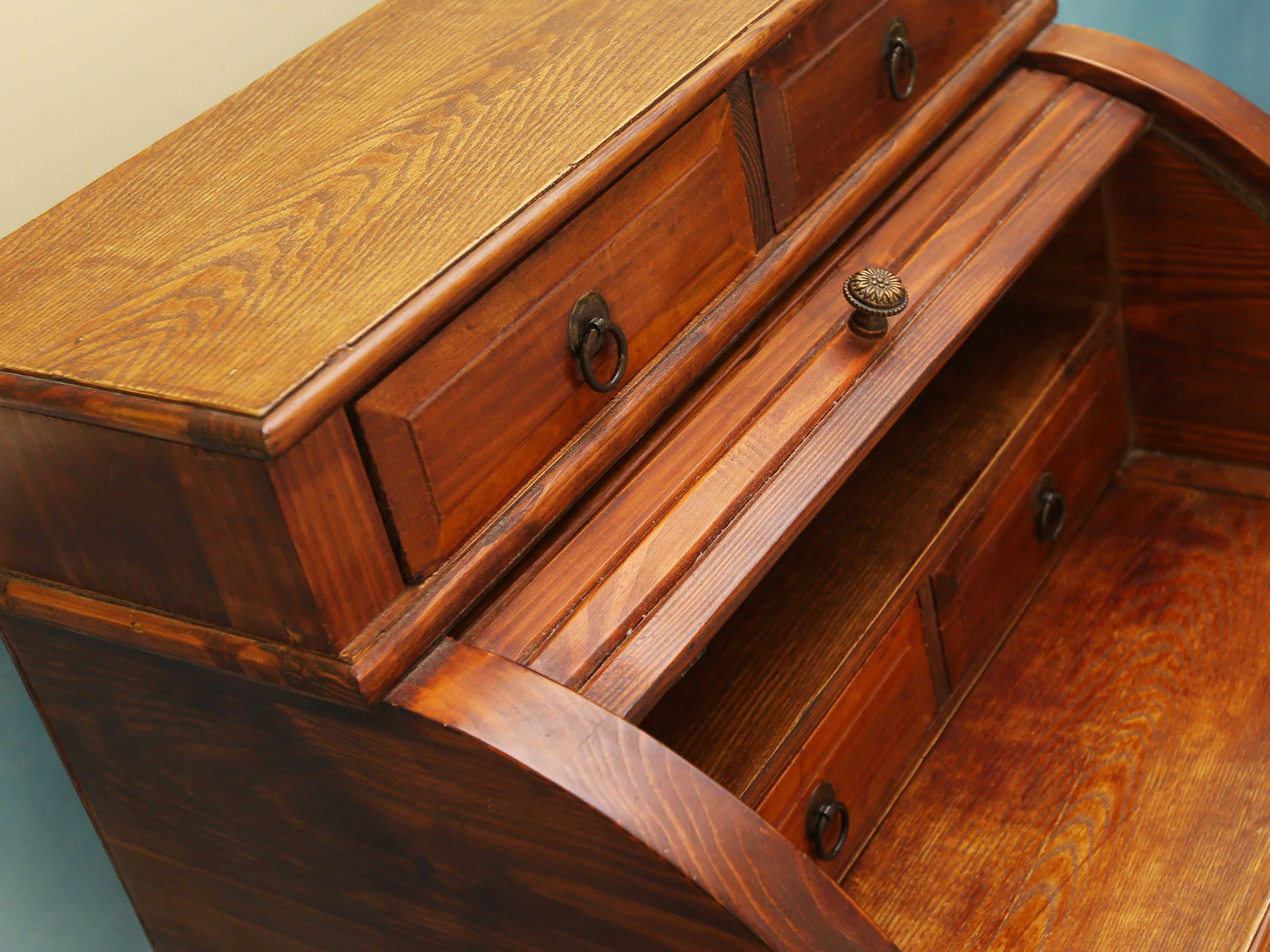 A wooden dresser with multiple drawers and knobs.