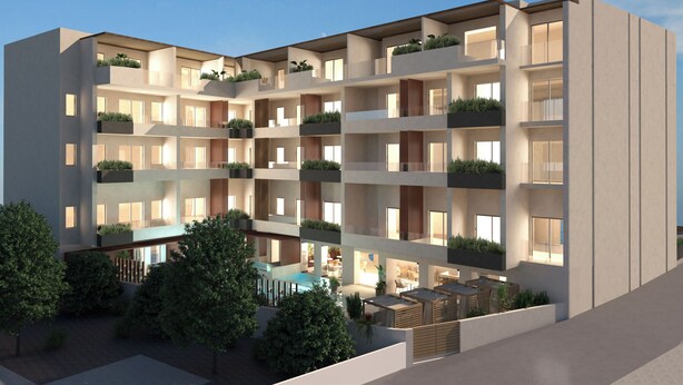 A multi-story building with balconies, a pool, and outdoor seating.