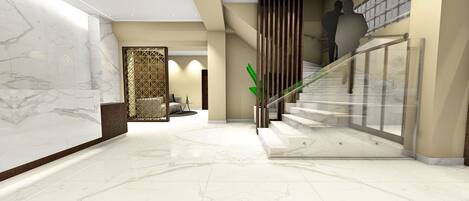 A modern lobby with marble flooring, a glass staircase, and a decorative wall panel.