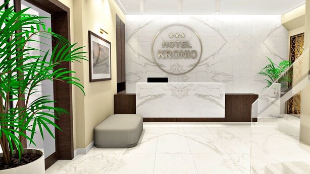 A hotel reception area with a marble floor, a reception desk, a staircase, and a potted plant. - Kronio (Archaia Olympia)