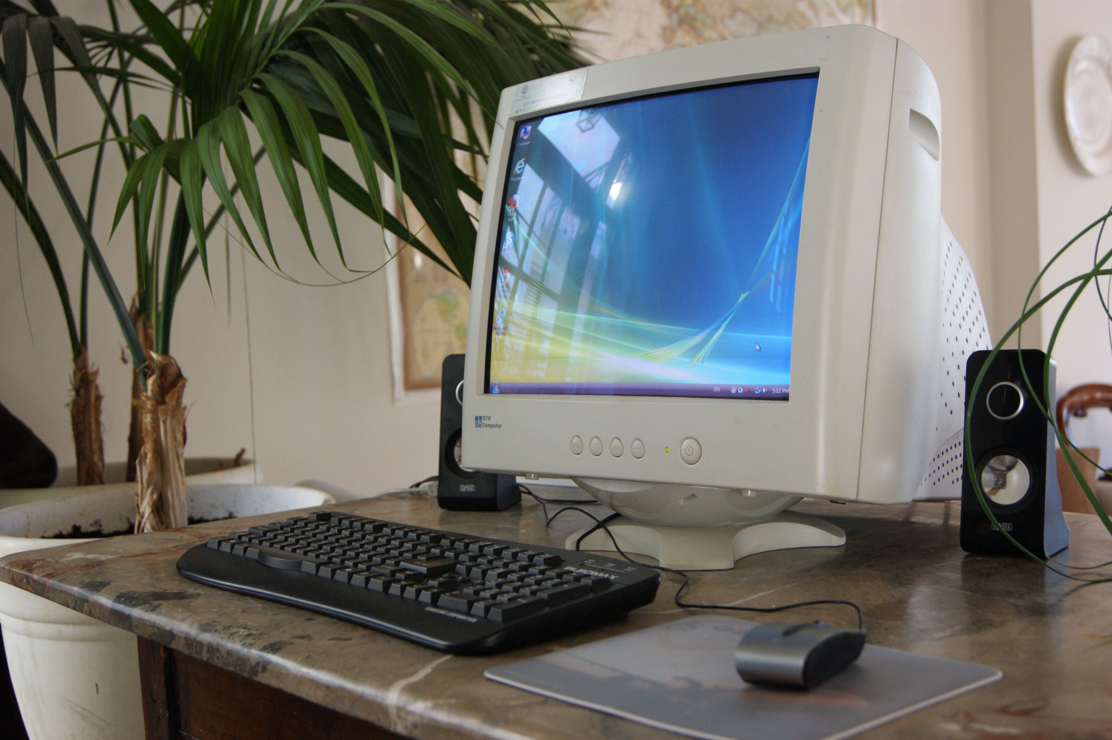 A desktop computer with a monitor, keyboard, and mouse on a desk.