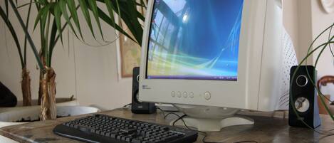 A desktop computer with a monitor, keyboard, and mouse on a desk.
