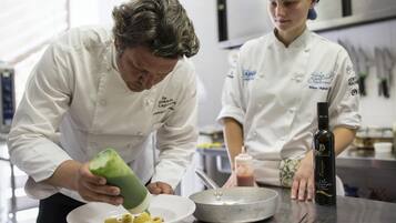 Two chefs in a kitchen preparing food.
