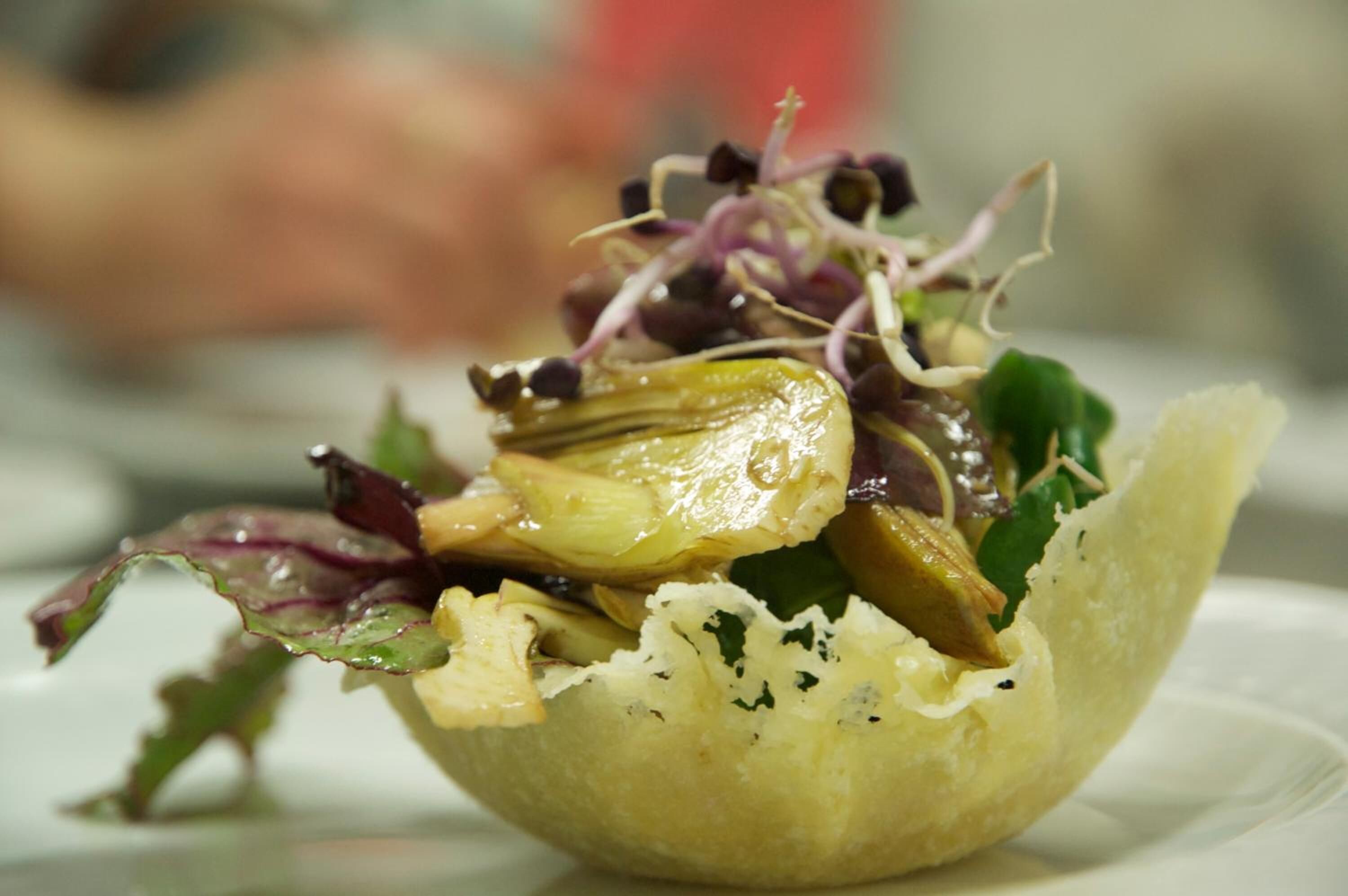 A salad with various vegetables and greens in a bowl.
