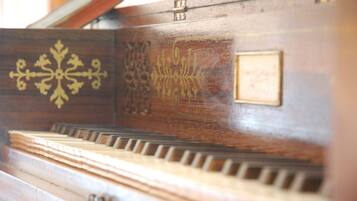 A close-up of a piano with intricate designs and a plaque.