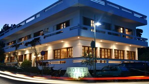 A multi-story hotel with a prominent sign reading "HOTEL HERCULES." - Hercules (Archaia Olympia)