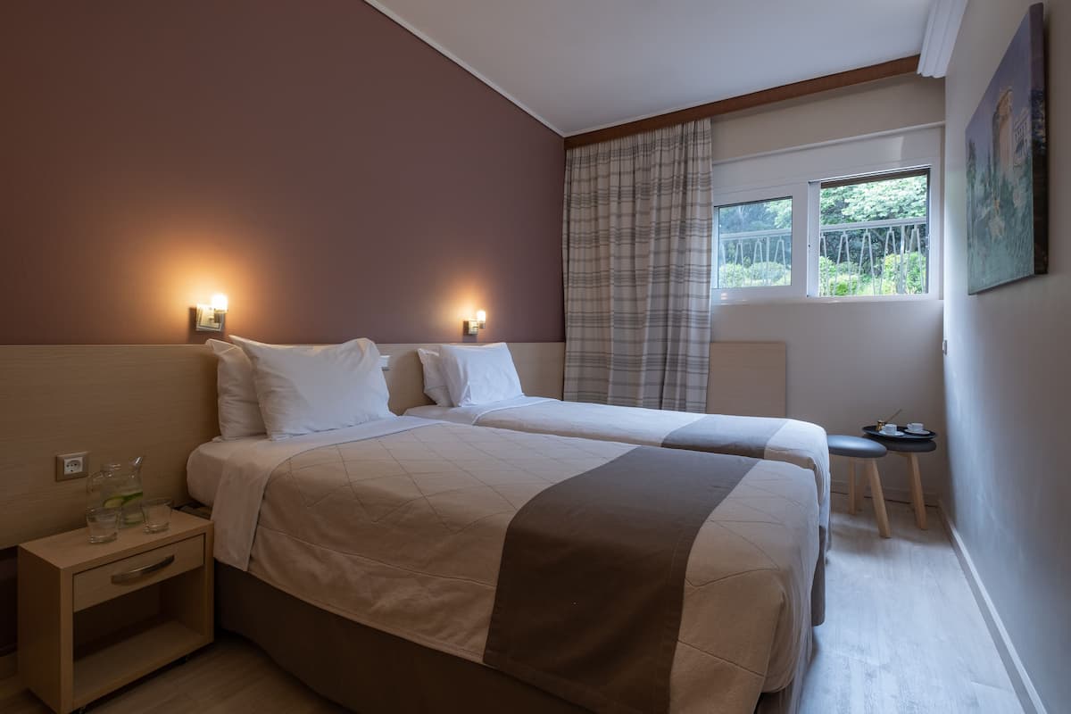 Economy Twin Room (1st floor- semi basement room) | In-room safe, desk, blackout drapes, iron/ironing board