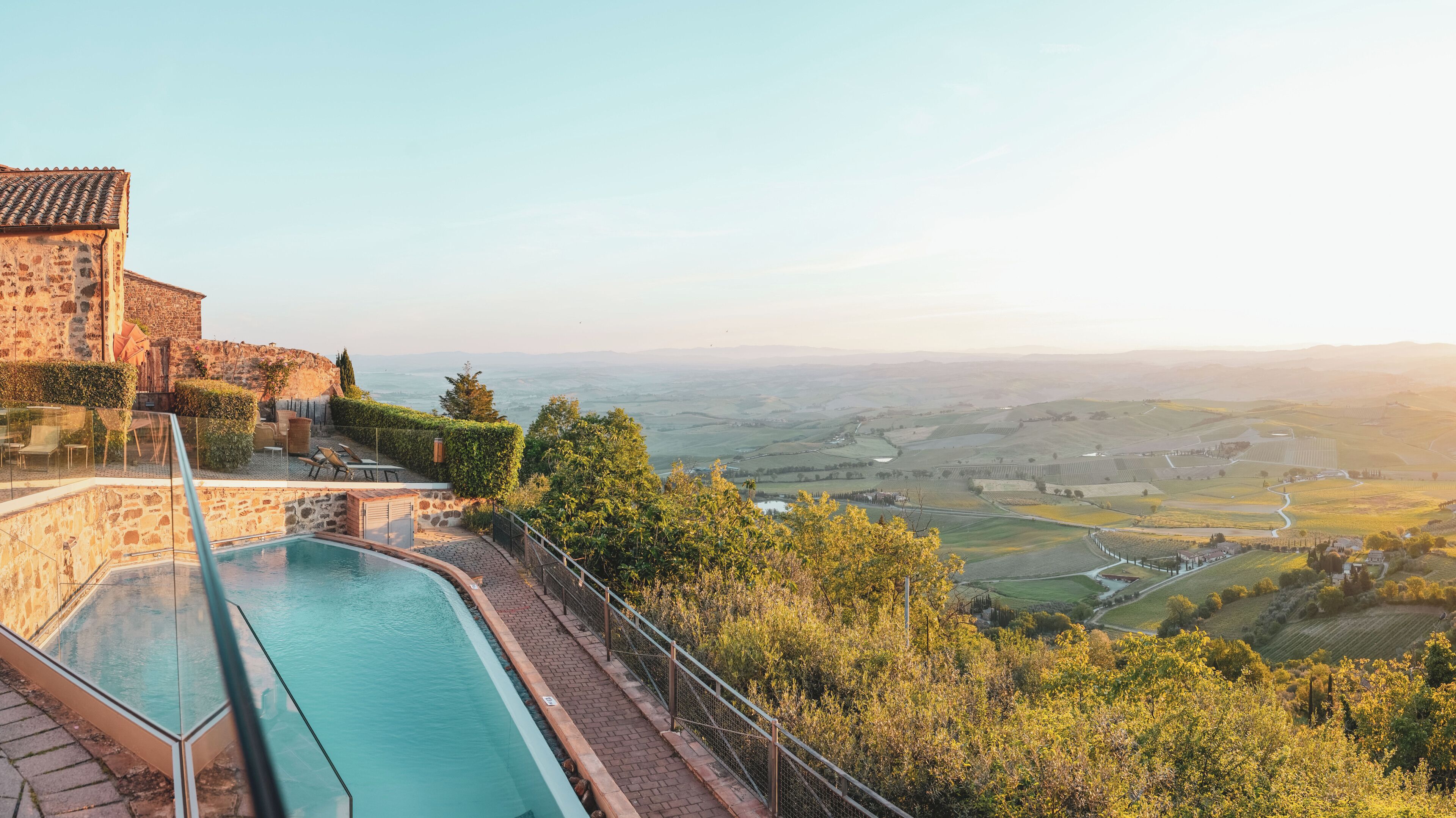 Una piscina al aire libre, sillones reclinables de piscina