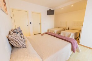 Deluxe Quadruple Room | Minibar, in-room safe, desk, iron/ironing board