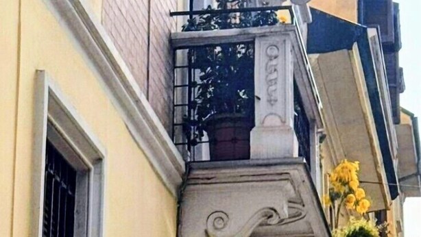 A hotel sign with 'HOTEL' and 'Malta' on the facade.