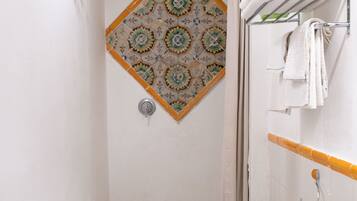 A bathroom with a shower, a toilet, and a sink.