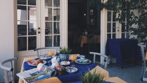 A dining area with a table set for breakfast, including croissants, juice, and a newspaper. - Albergo della Corona (Binasco)
