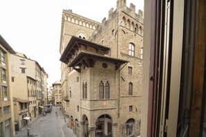A historic stone building with arched windows and a clock tower. - Repubblica Bed & Breakfast (Florence)