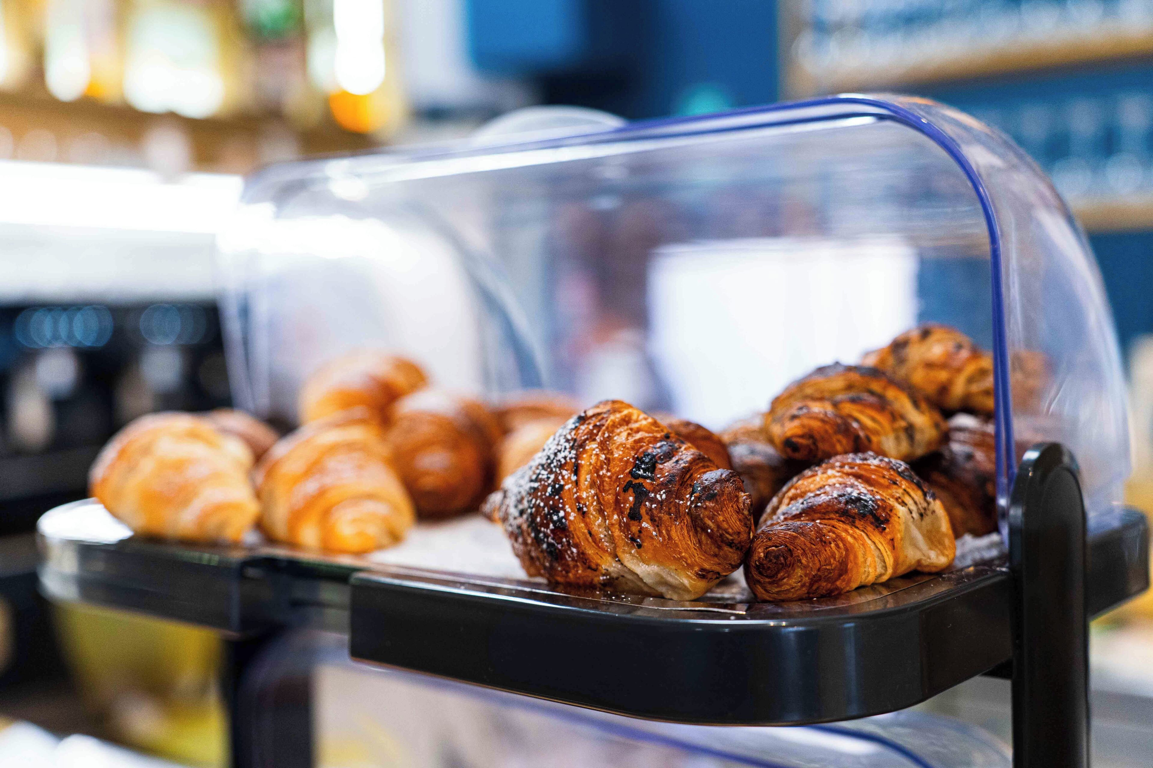 A bakery display case with croissants.