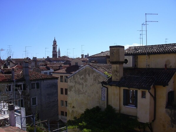 A view of a town with buildings, including a prominent tower and various rooftops.