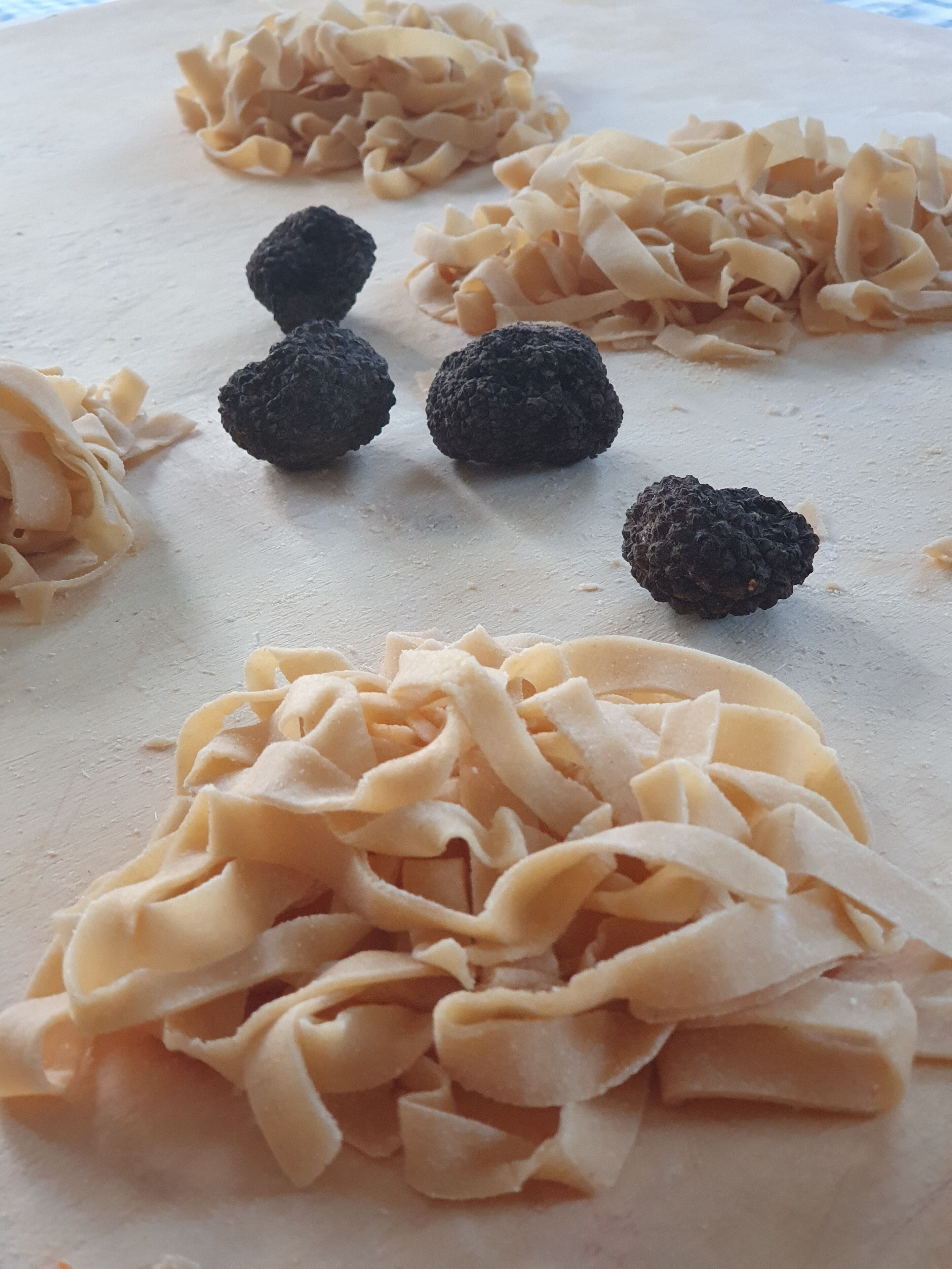 A table with pasta and black truffles.