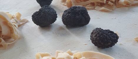 A table with pasta and black truffles.
