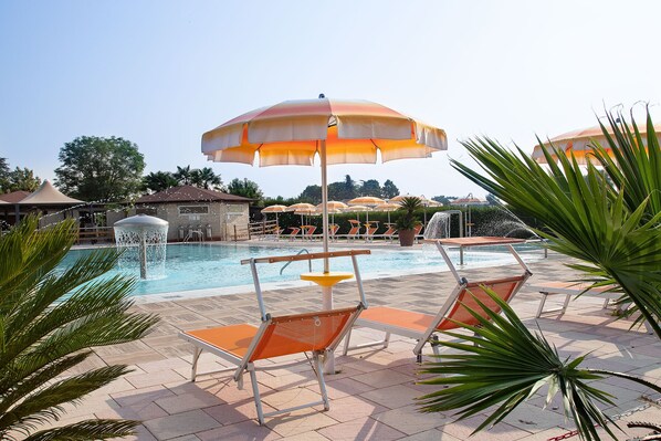 Indoor pool, seasonal outdoor pool, pool umbrellas, pool loungers