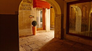 Ein gebogener Eingang zu einem Hotel mit dem Schriftzug "HOTEL LISBONA".