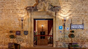 A stone building entrance with a sign indicating a hotel. - Parador de Olite (Olite)