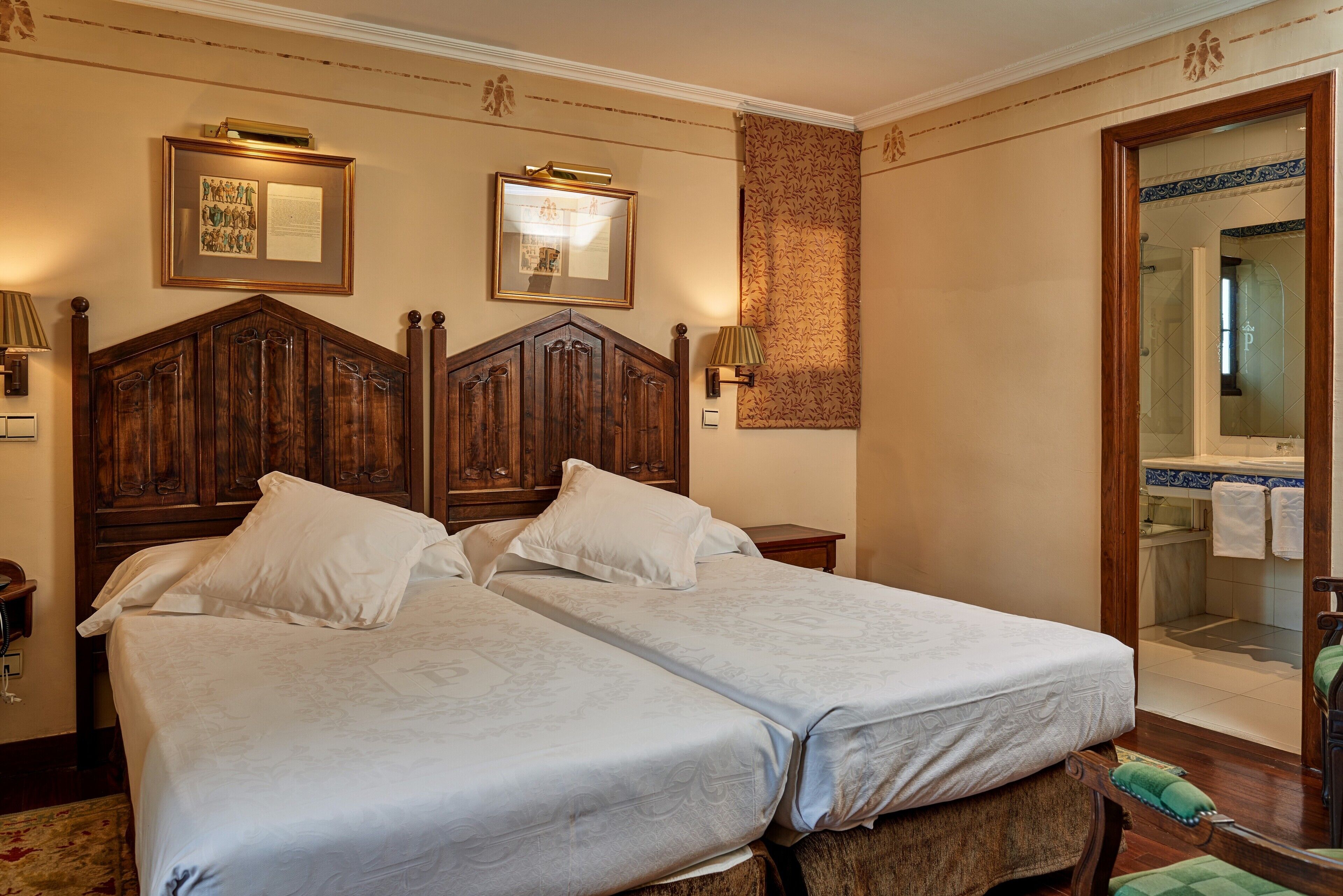 A double bed with a wooden headboard, two bedside tables, and a mirror.