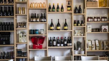 A wine cellar with shelves stocked with various bottles and boxes of wine.