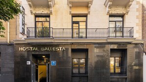 A building with a sign reading "HOSTAL BALSESTA" and a blue handicap accessibility sign. - Hostal Ballesta (Madrid)