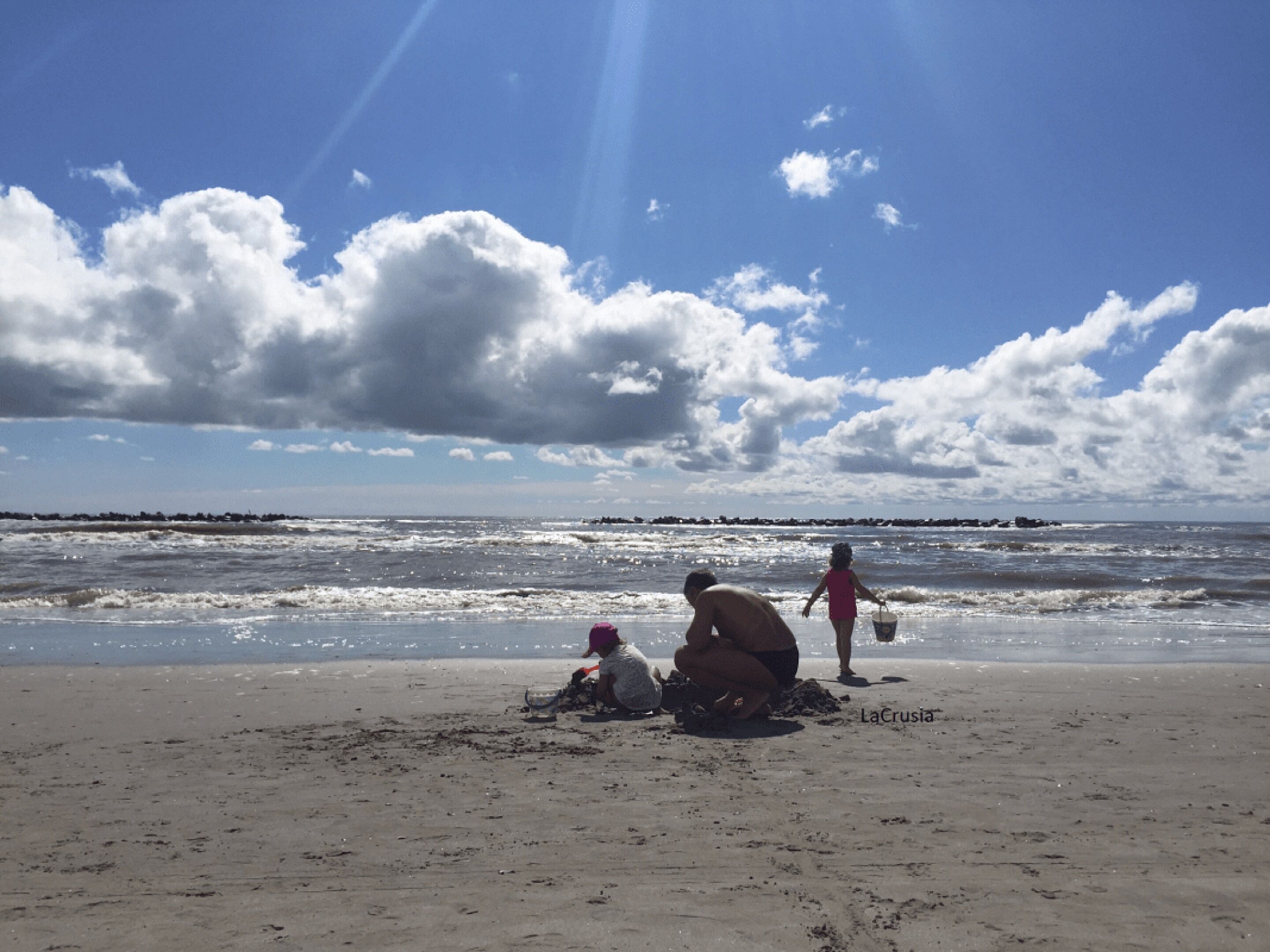 A beach with a clear sky and waves.