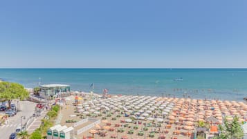 On the beach, sun-loungers, beach towels, beach yoga