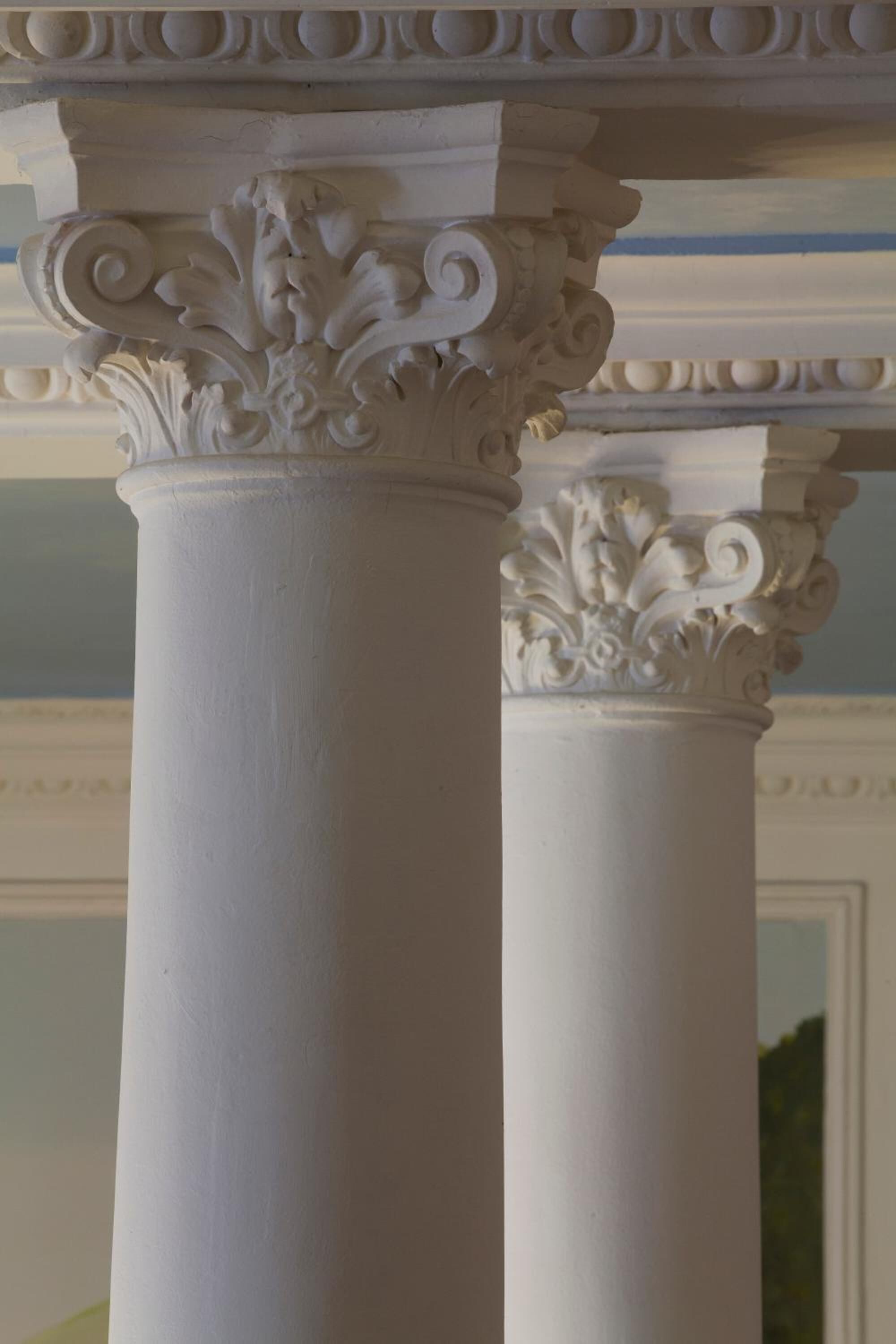 A close-up of a white column with ornate capitals.
