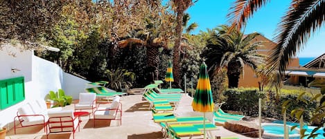 Seasonal outdoor pool, open 9:00 AM to 8:30 PM, pool umbrellas